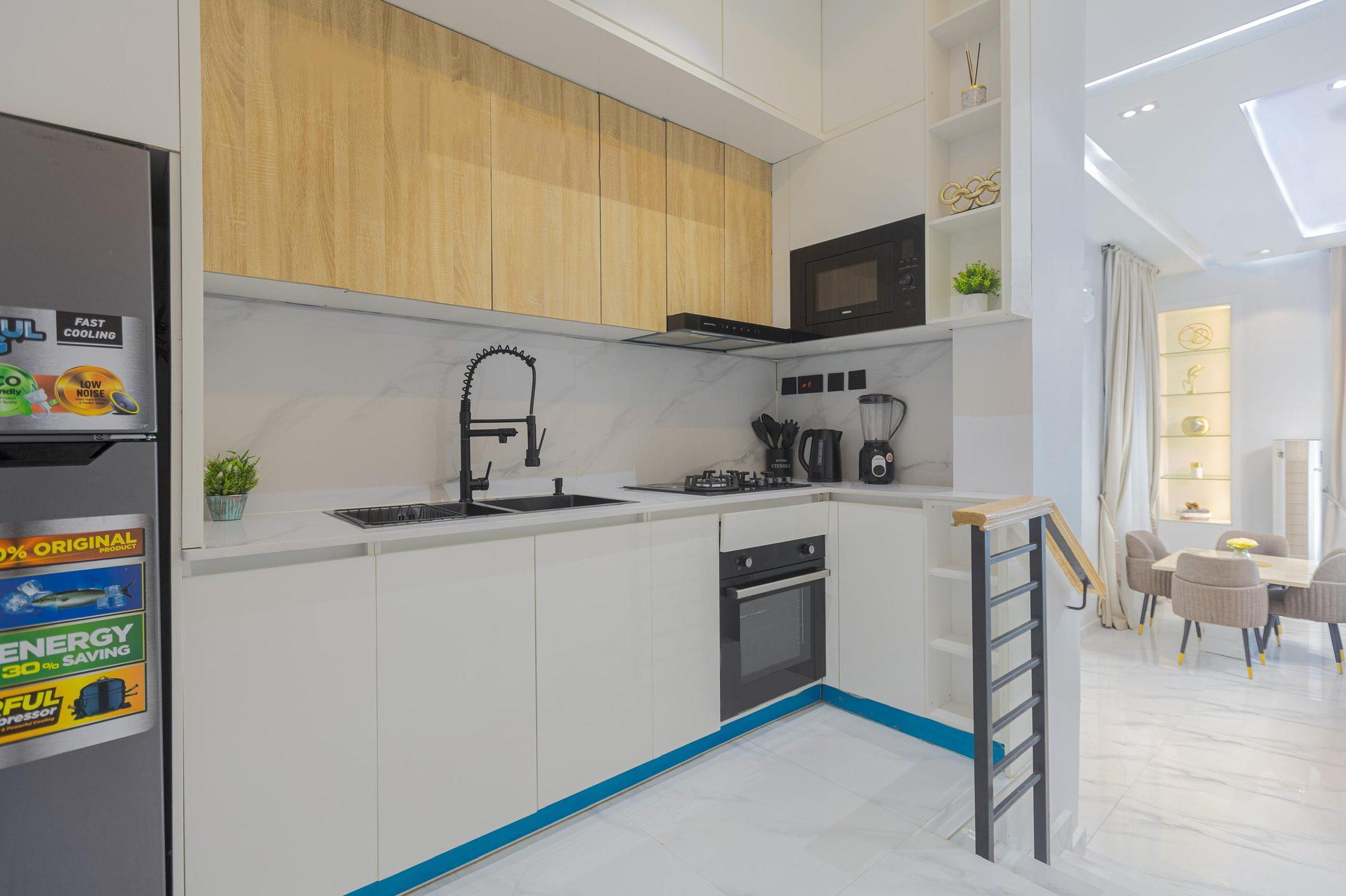 Wide view of a fitted duplex kitchen by Valdo Interiors